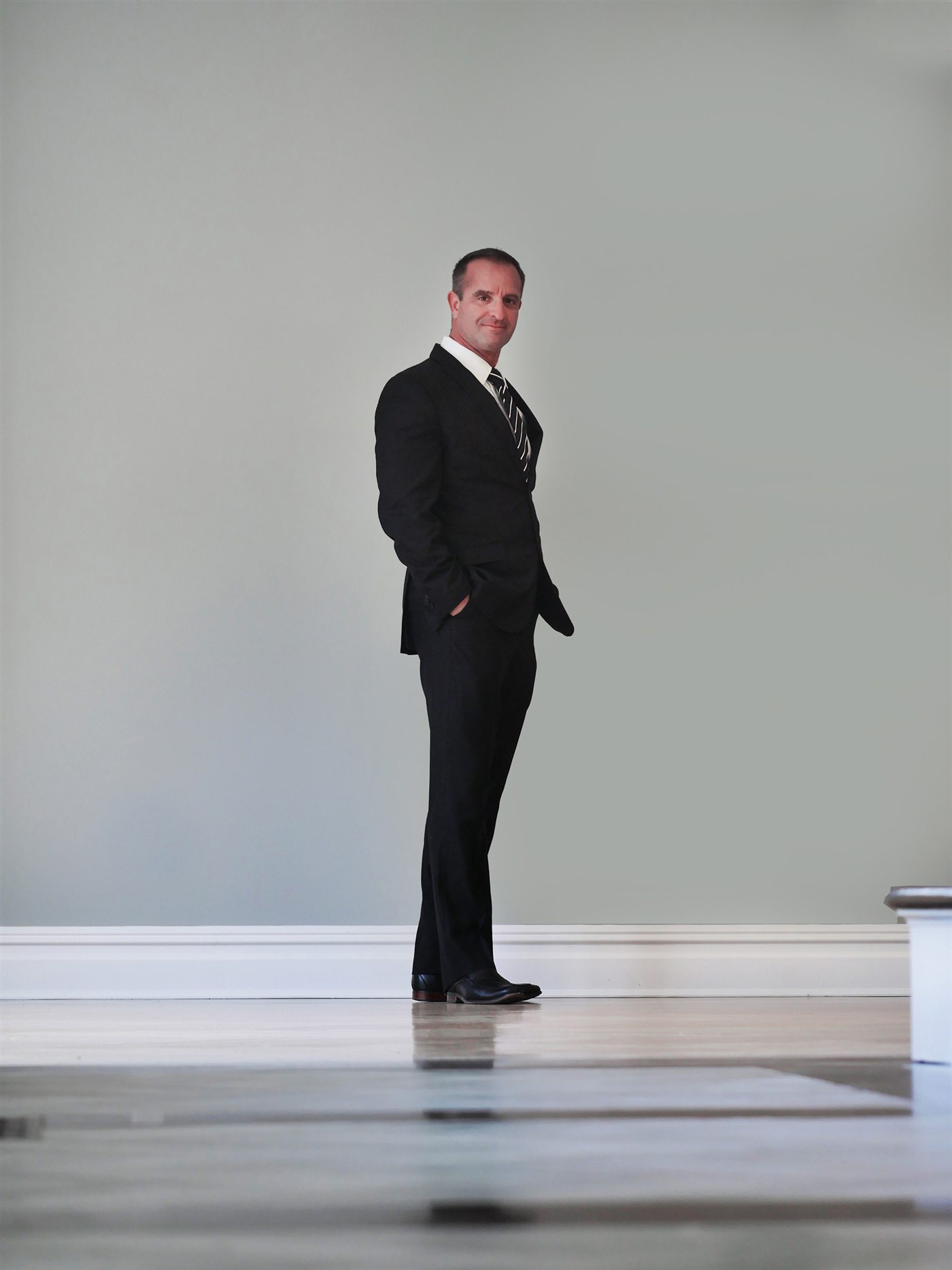 Jerry Villani standing in an empty listing